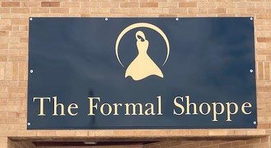 Glossy black sign with gold letters for the name The formal shoppe