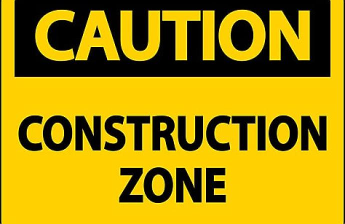 Yellow construction sign stating Construction Zone